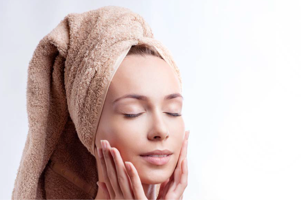 A women applying cream after shower A women applying cream after shower